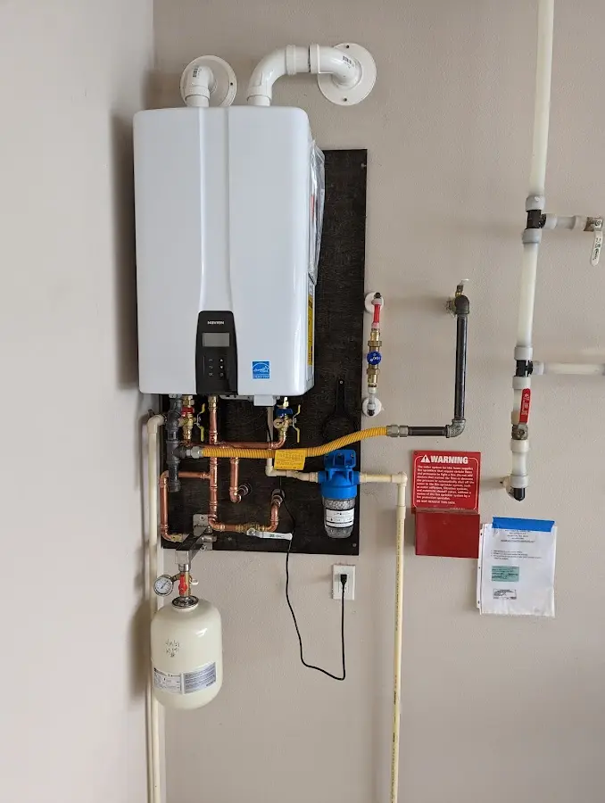 Professional plumber installing copper piping in a Munroe Falls home